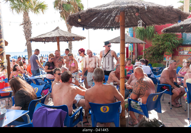 British men drinking at bar on the waterfront, Benidorm, Costa Blanca, Spain Stock Photo