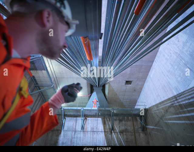 Civil Engineers Inspecting Cable Anchorage In Suspension Bridge, Low