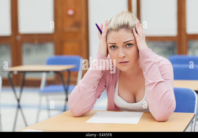 woman-looking-worried-over-exam-paper-e4