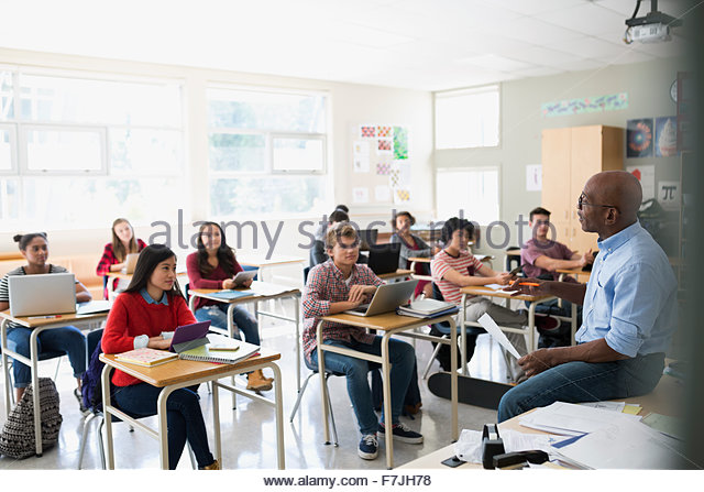 High school students listening to teacher in classroom Stock Photo ...